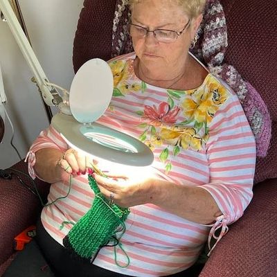 Client using a lighted magnifier. 