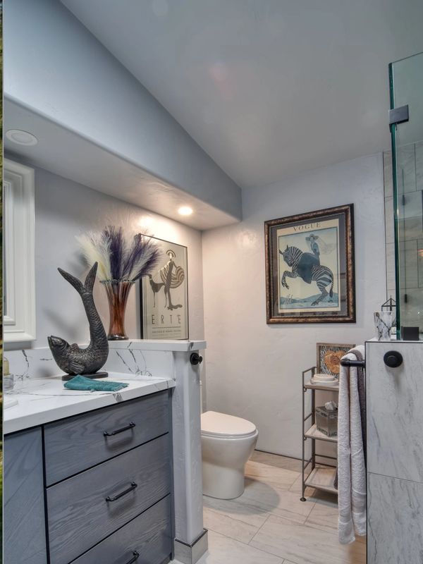 Modern bathroom with art and decorative accents.