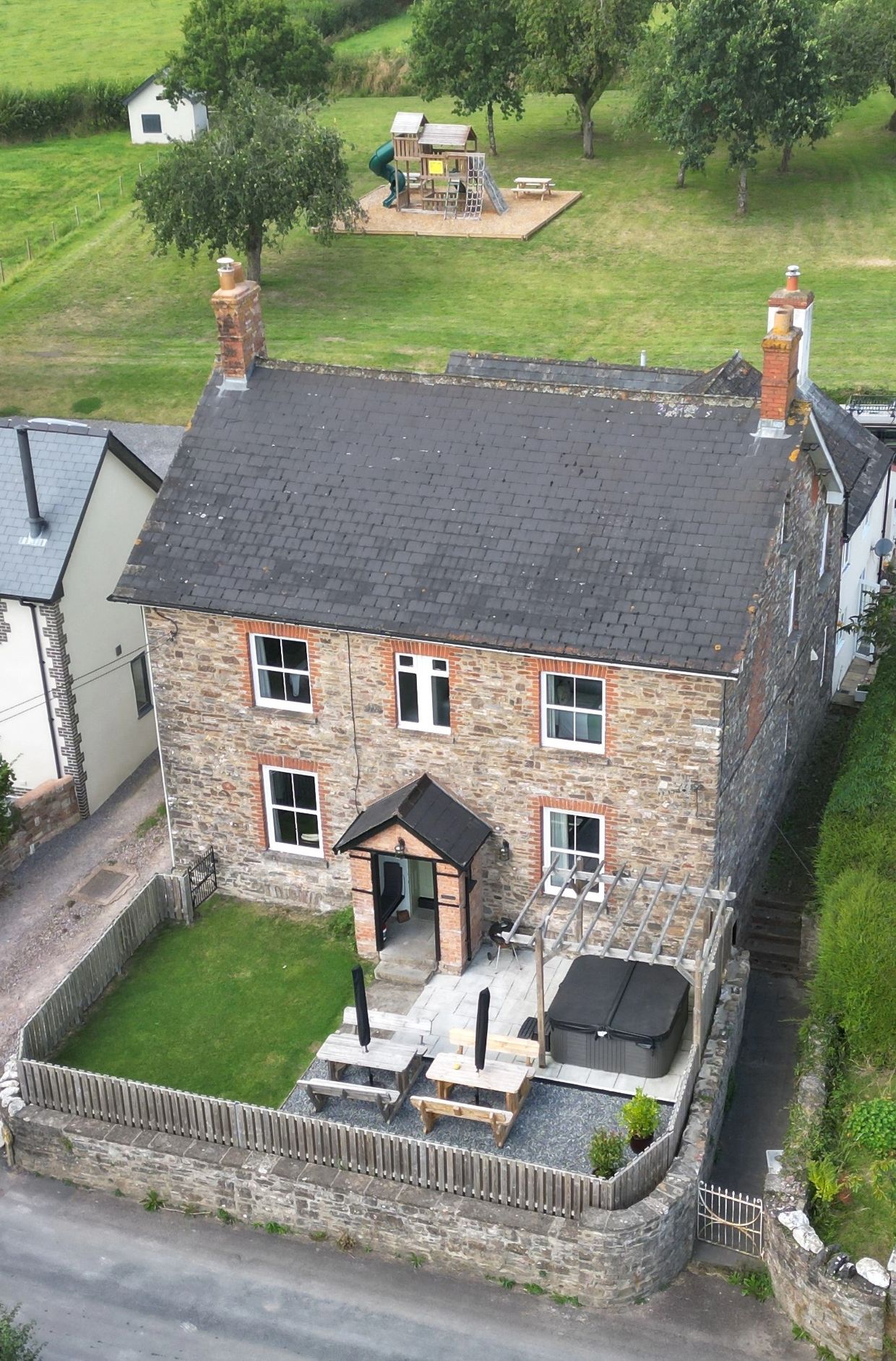 Aerial view of our self-catering accommodation. With enclosed front garden. Orchard play area.