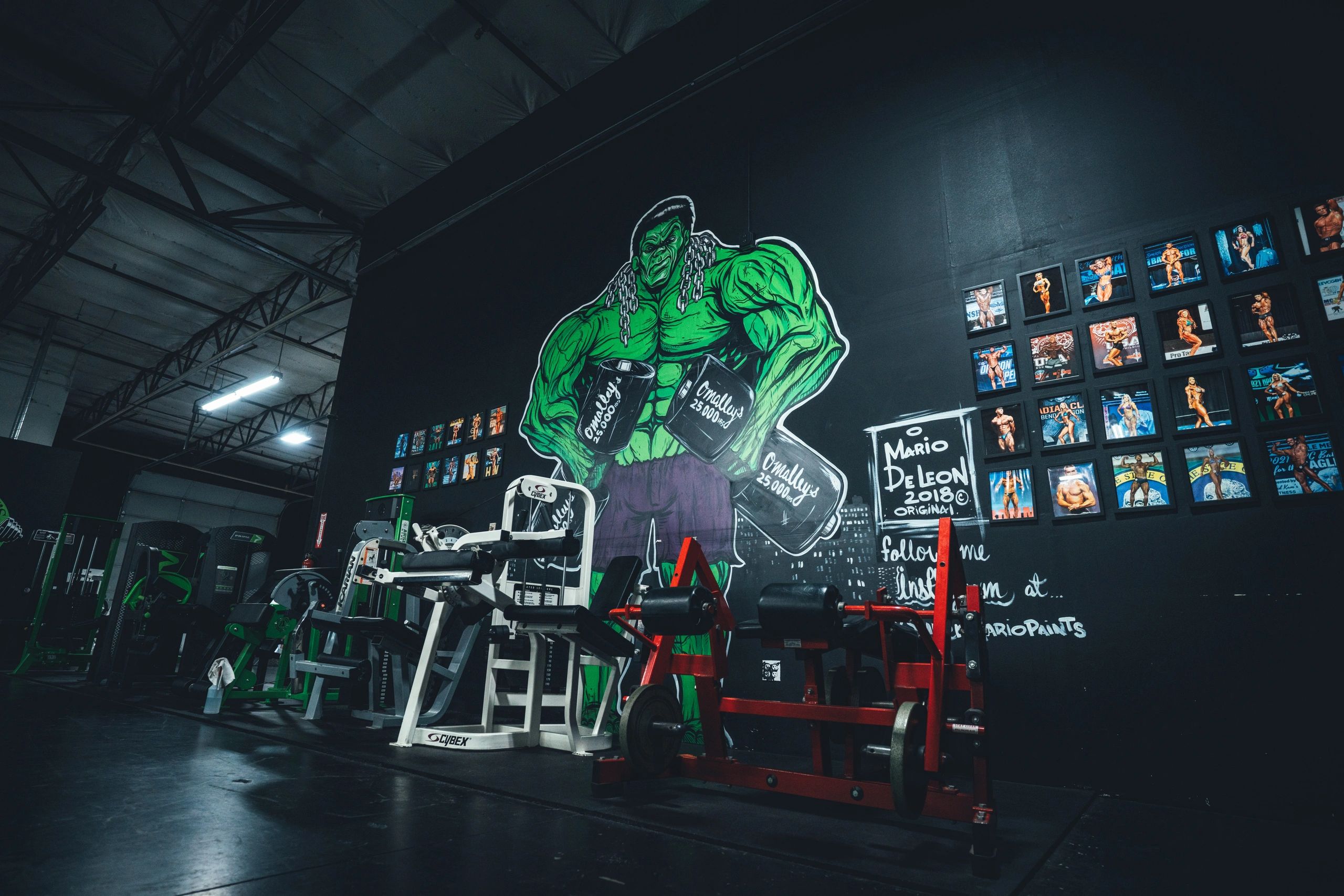 Plate-loaded machines under the Hulk mural
