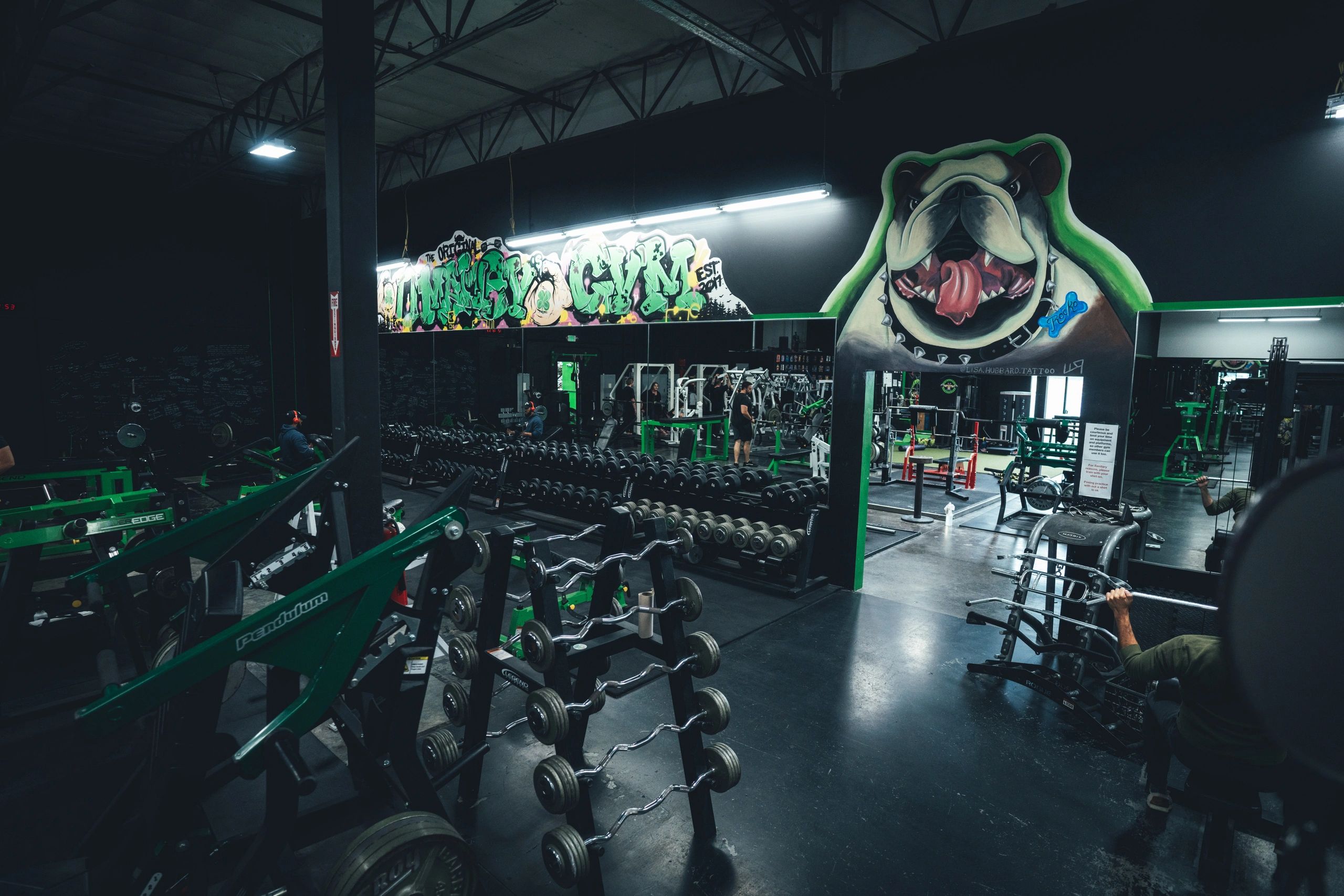 O'Malley's training floor with the bulldog mural and dumbbell racks