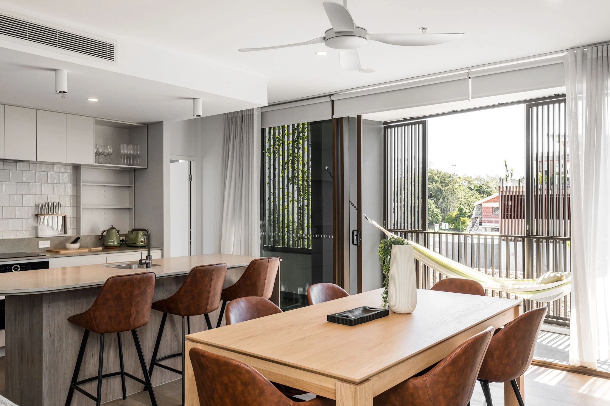 Kitchen and dining area with island bench and stone surfaces