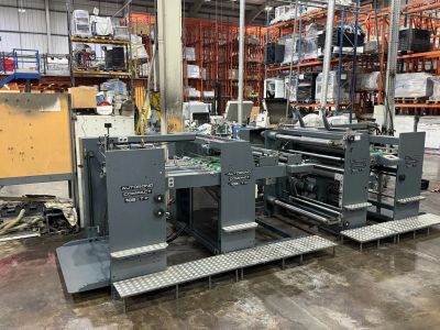 Large industrial printing machine in a warehouse setting.