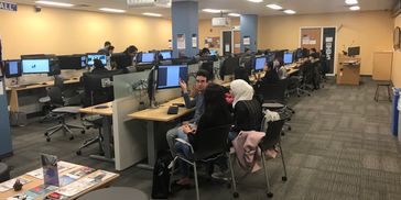 People working on computers in a computer lab.