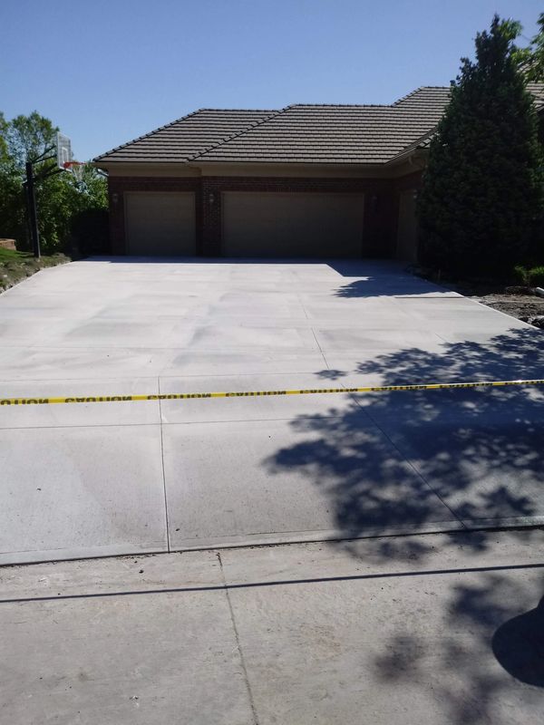 Freshly poured concrete driveway with caution tape.