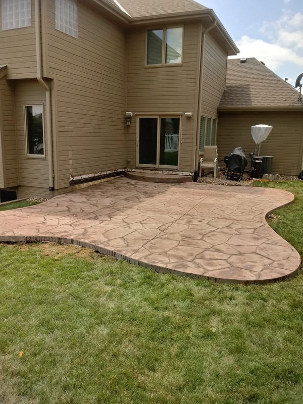Stamped concrete patio with a curvy design.