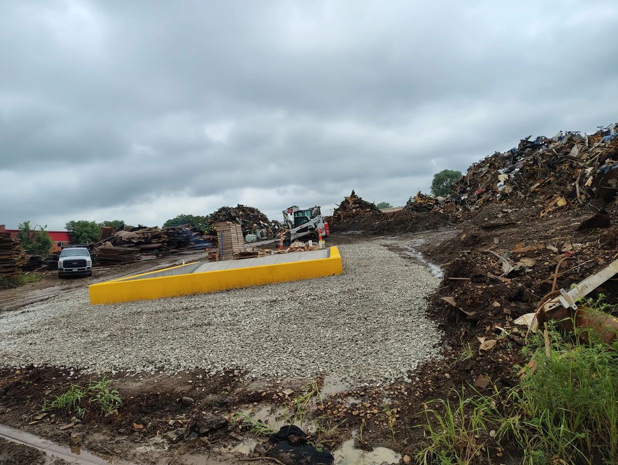 Construction site with gravel and heavy machinery.