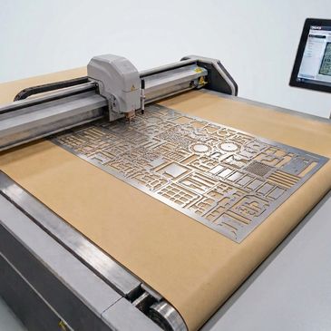 Laser cutting metal sheet with intricate patterns.