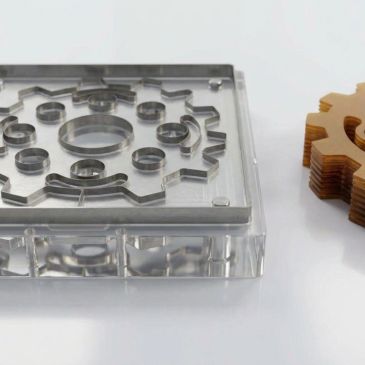 Clear acrylic mold and wooden gear-shaped cookie cutter.