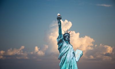 Statue of liberty with bright clouds behind