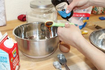 Pouring vanilla into a bowl. 