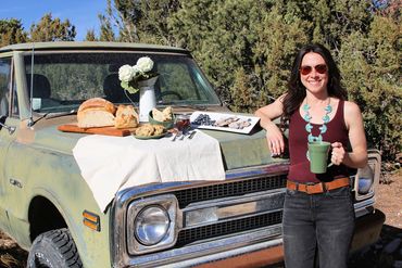 A picnic on the hood of a truck. 