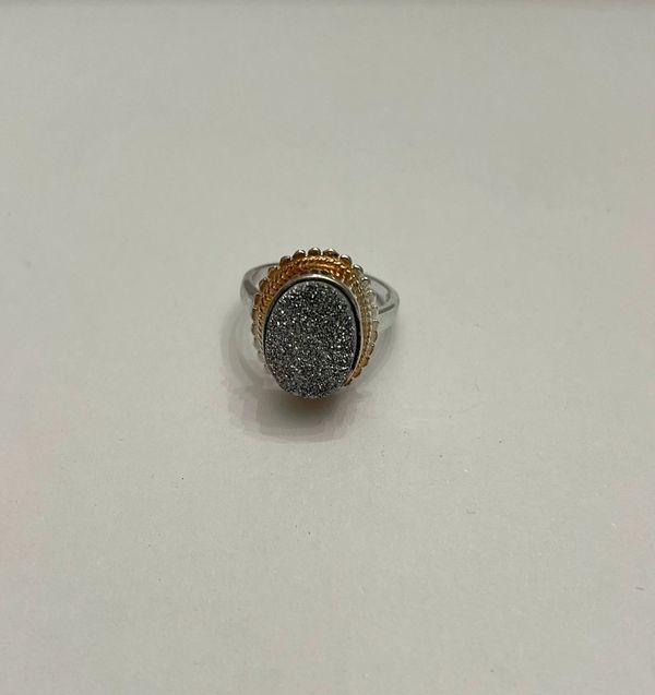 Oval druzy ring featuring a gold-tone bezel setting and a silver-tone.