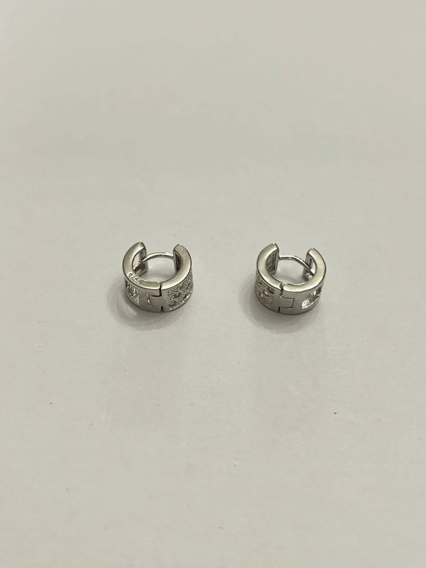 Silver Huggie hoop earrings.