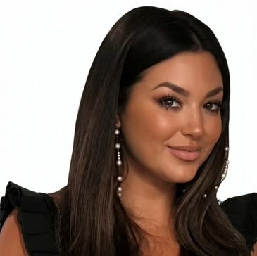 Woman with long dark hair and pearl earrings.