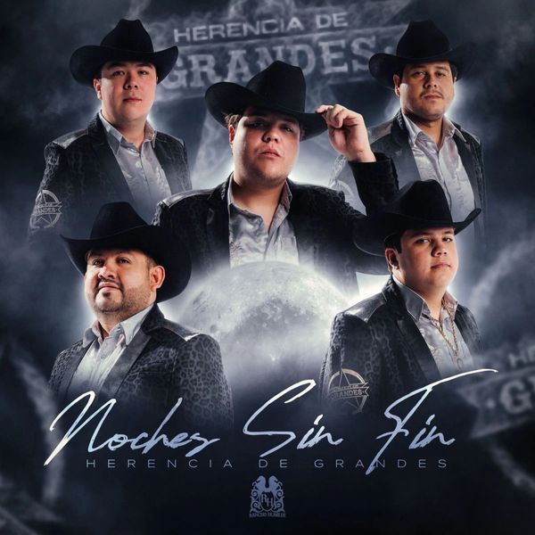 Band members of Herencia de Grandes wearing cowboy hats in a smoky, dramatic setting.
