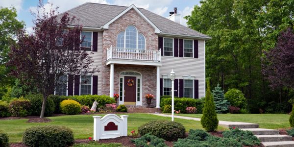 Financial goal achieved of safe luxury feel-good home and yard with family and prosperity protected.