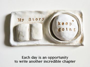 White ceramic with motivational text about continuing one's story.