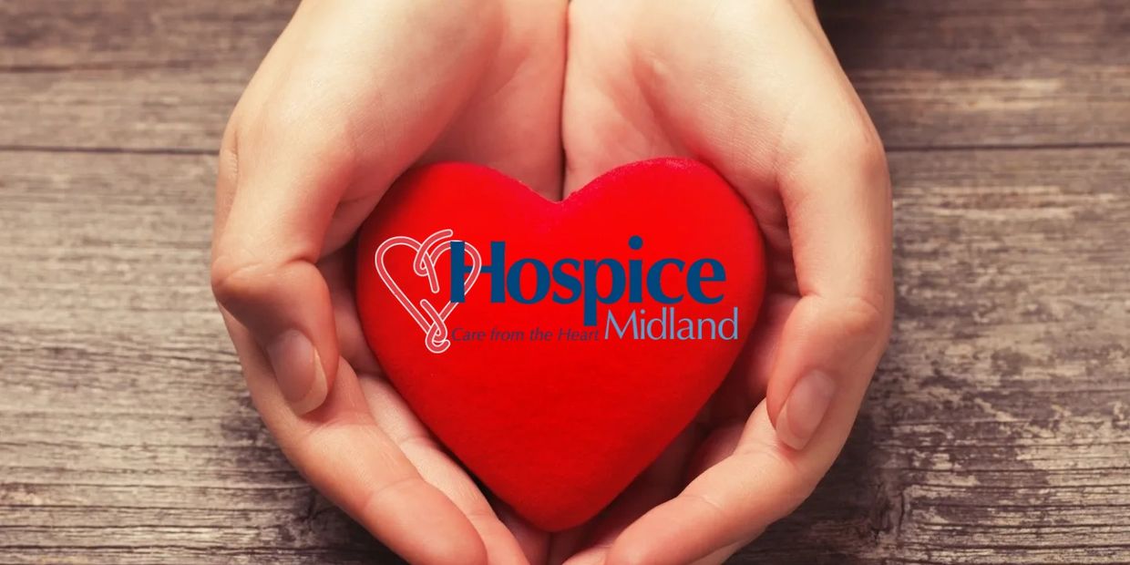 Hospice Nurse holding heat with Hospice of Midland Logo