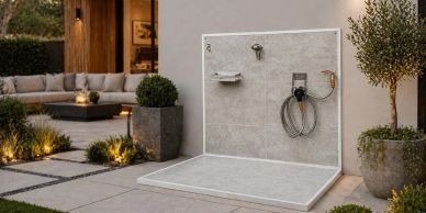 Elegant outdoor shower area with modern design and plants.
