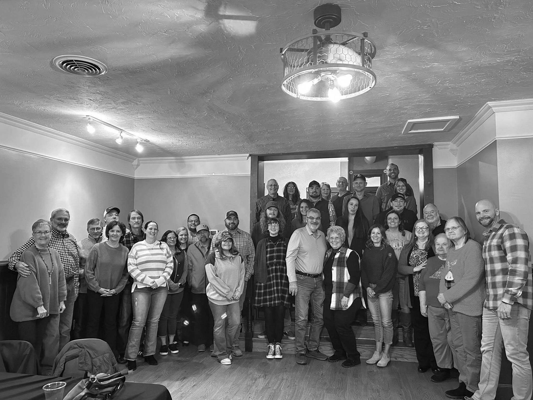 A large group of people posing indoors.