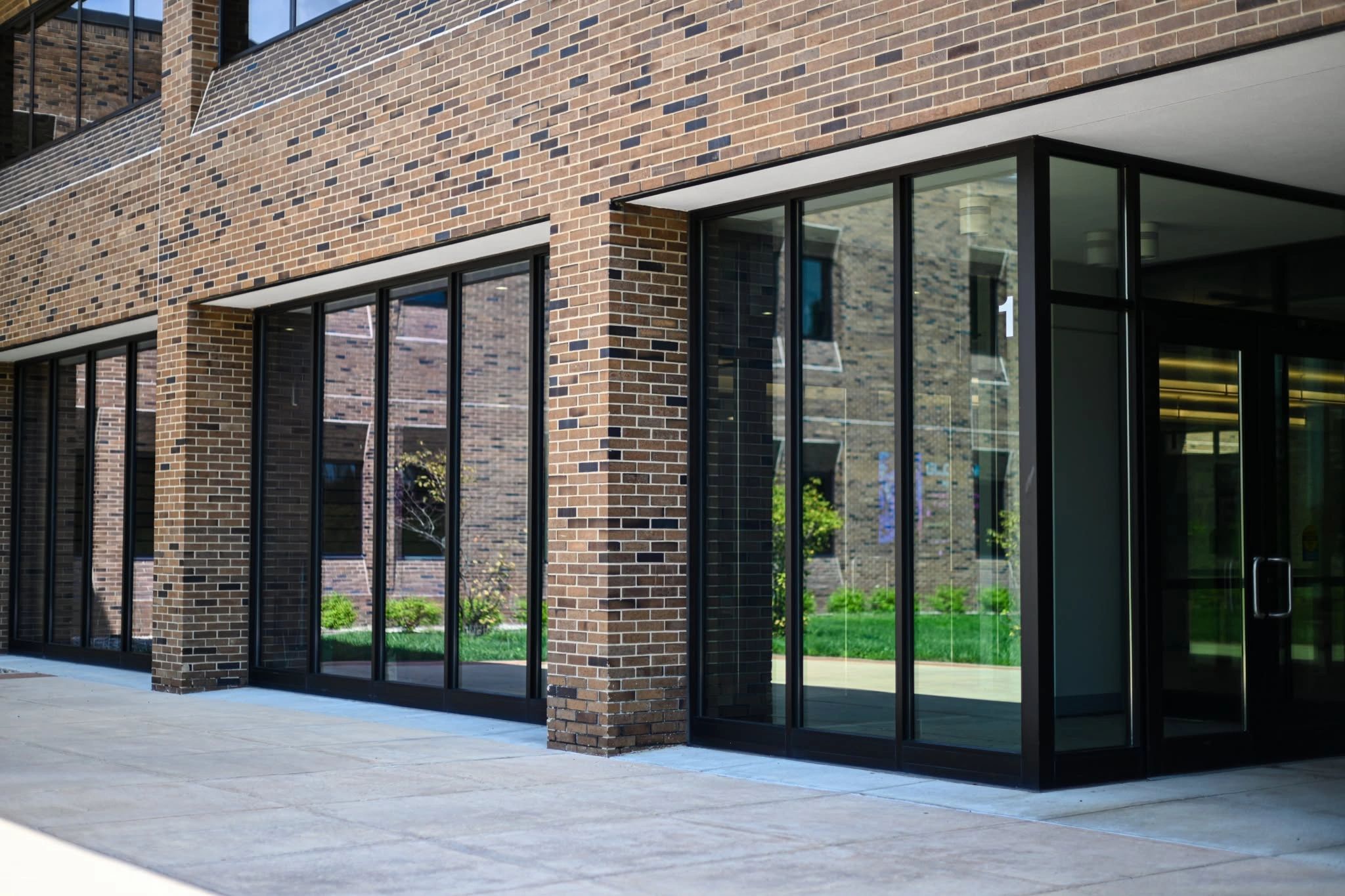 Modern brick building with large glass windows.