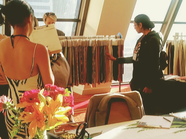 People browsing fabric samples at a textile event.