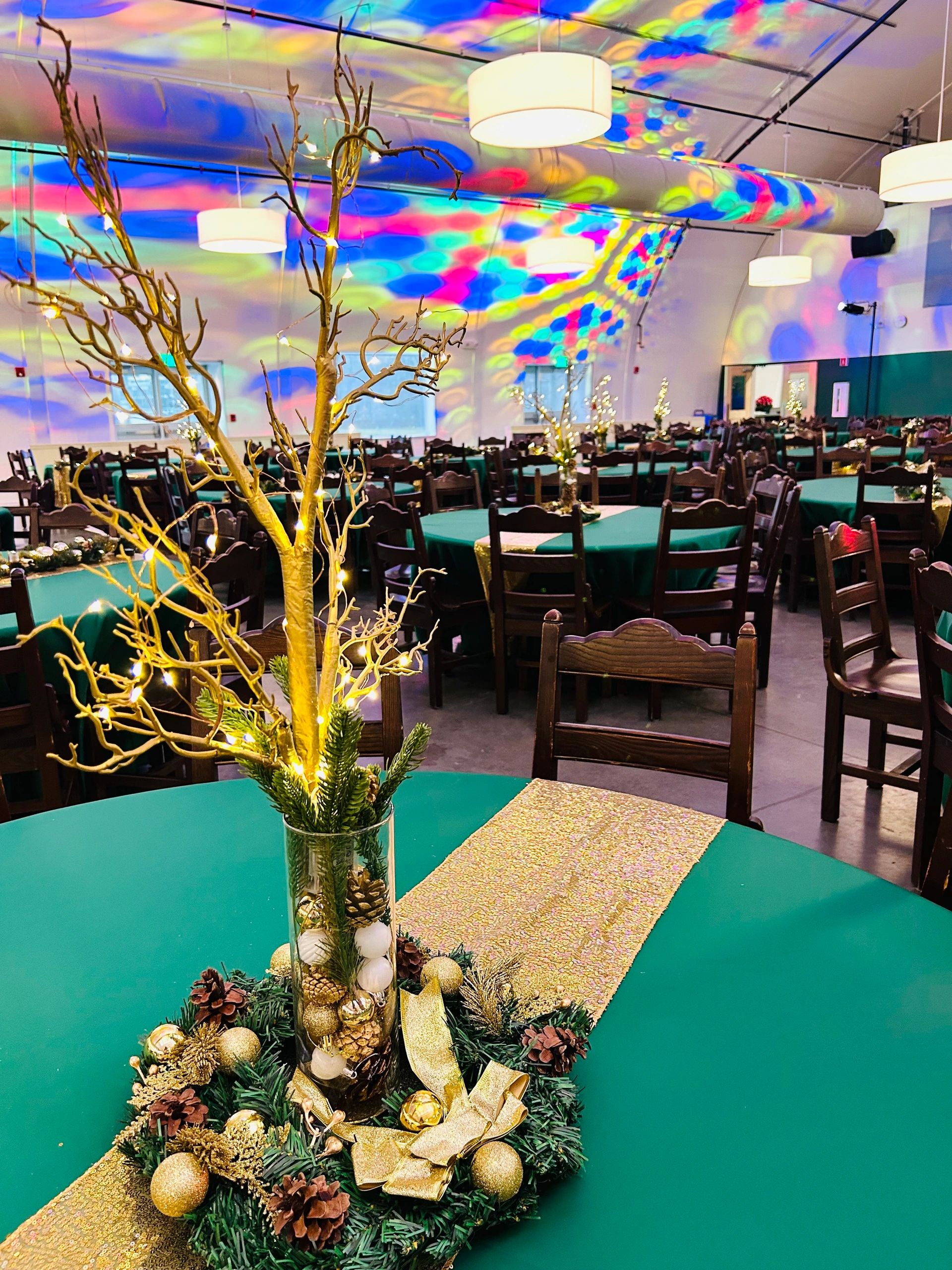 Festive banquet hall with colorful lights and elegant centerpieces.