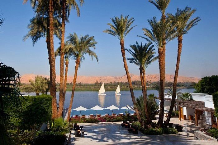 Feluccas sailing the Nile at Aswan as the sun sets over the river