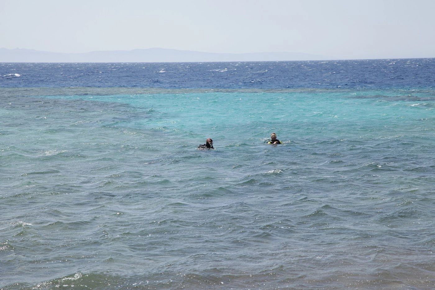 A snorkeling boat over a turquoise Red Sea reef