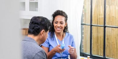 A healthcare professional explains a medical device to a patient.