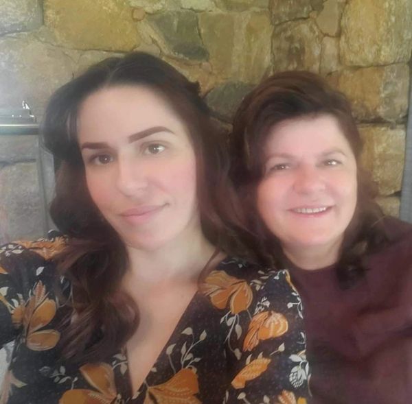 A heartwarming selfie capturing a mother and daughter smiling together.