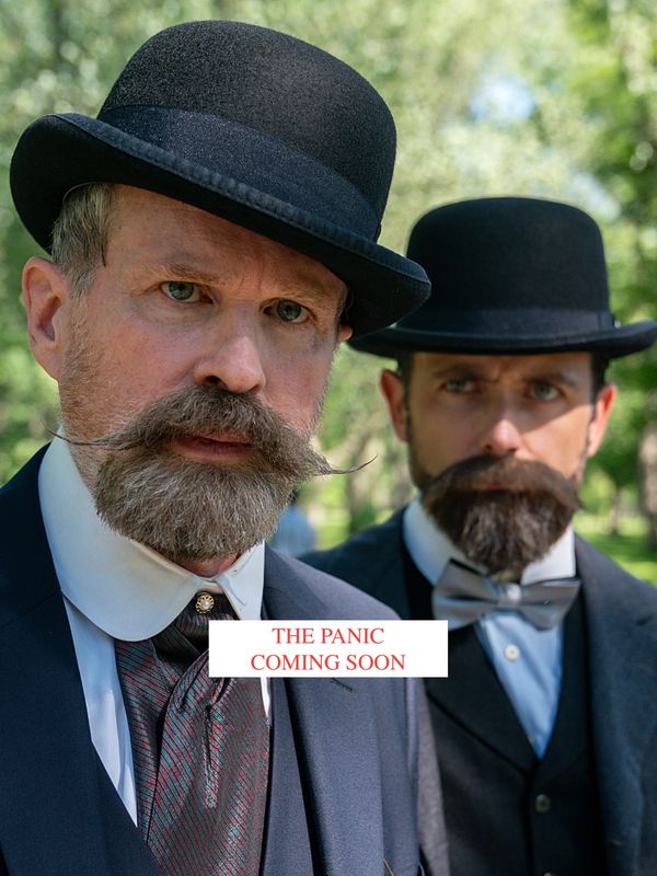 Two serious men in vintage suits and bowler hats with text 'THE PANIC COMING SOON'.