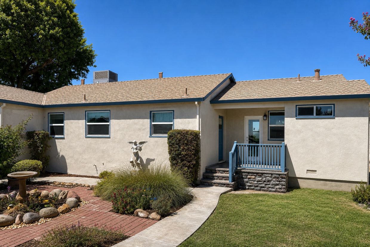 Exterior of a home addition in Gustine, CA, with new entry porch, stone-accented steps, and matching