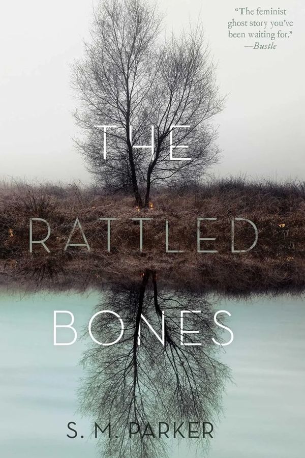 Book cover of The Rattled Bones by S.M. Parker with a reflective tree.