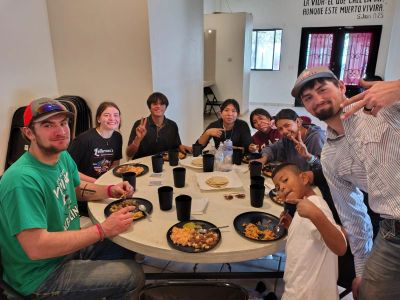 A group enjoying a meal together around a table.