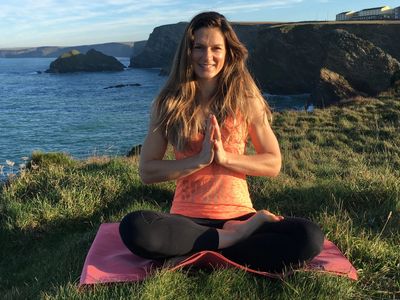 Ellie Murray does yoga by the sea in Cornwall