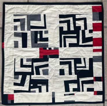 Fractured 1. 
Art quilt featuring variations on the log cabin block, hand quilted. Measures 18" x 18