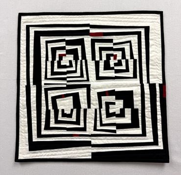 Fractured 2. 
Art quilt featuring variations on log cabin block, machine quilted. Measures 18" x 18"