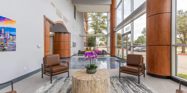 Modern lobby with seating and large windows.