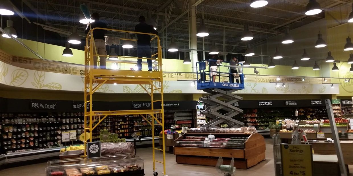 Using scissor lifts and scaffolding to high dust a grocery store