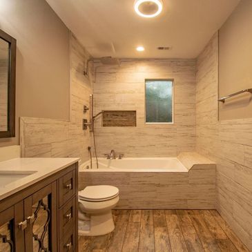 Classic Construction bathroom remodel in houston with tile, shower, tub, toilet, lighting fixtures 