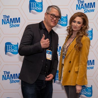 Two people posing with thumbs up at The NAMM Show.