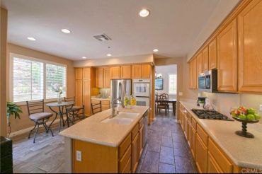 Spacious kitchen with wooden cabinets and island.