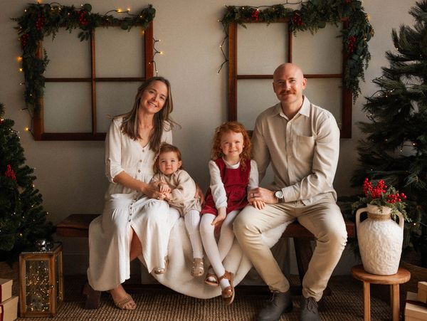 A family of four posing for a holiday photo.