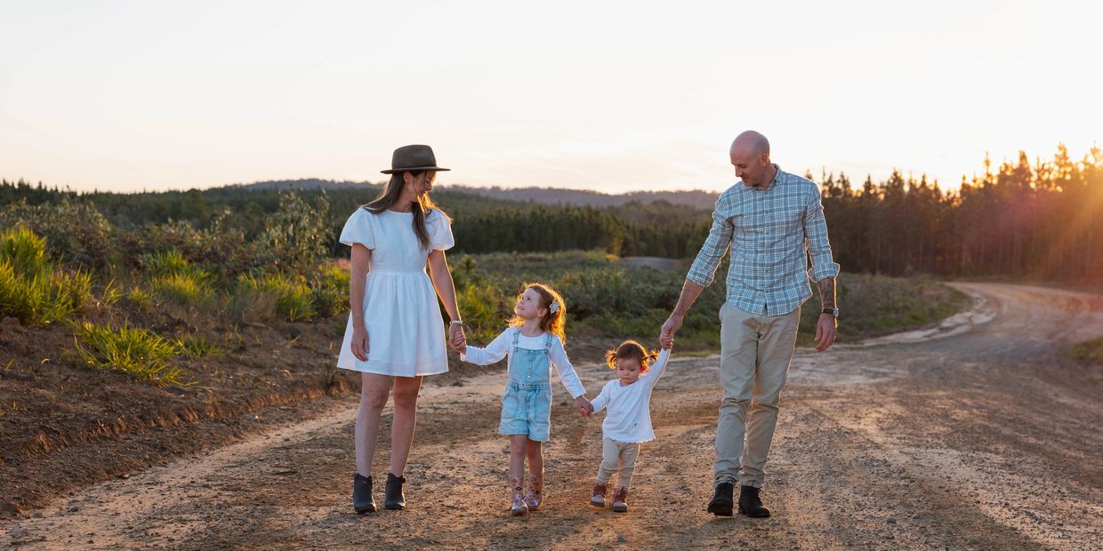 Family holding hands walking together during a photoshoot in Beerwah, Sunshine Coast.