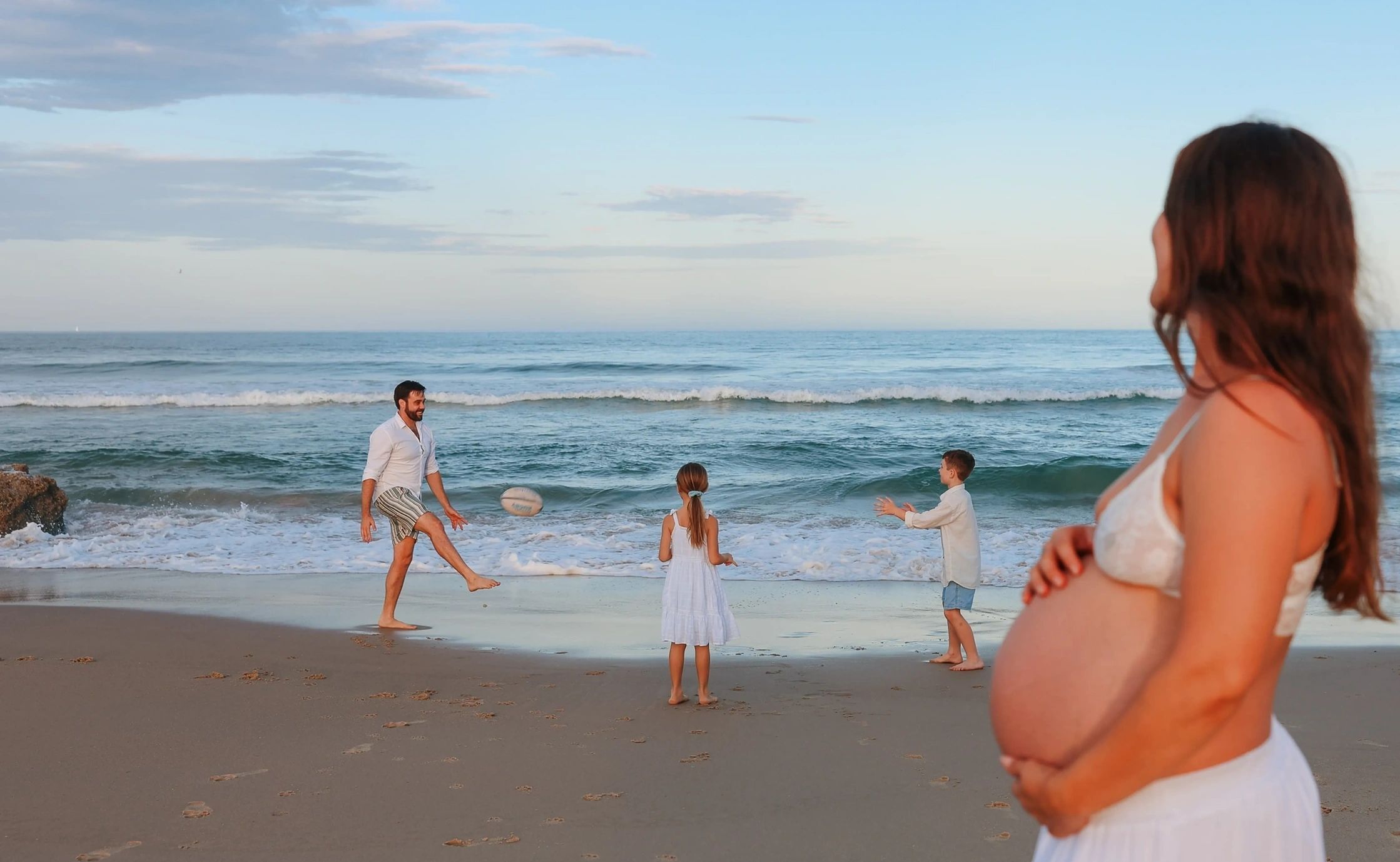 Sunshine Coast Family Photographer Taking photos of Family at Mudjimba Beach.