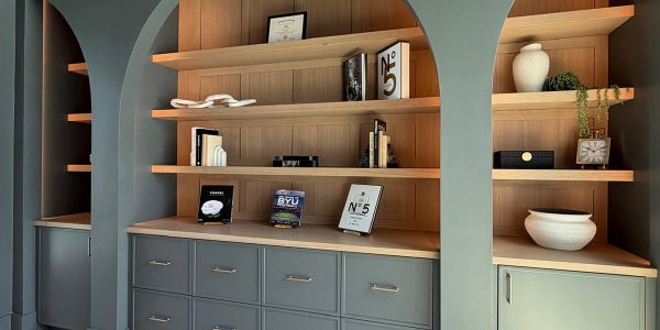 Modern wooden shelves with decorative items and books.