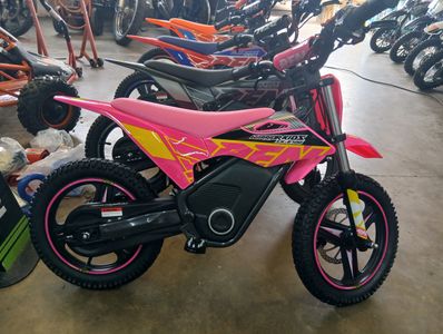 Pink and yellow kids' dirt bike in a showroom.