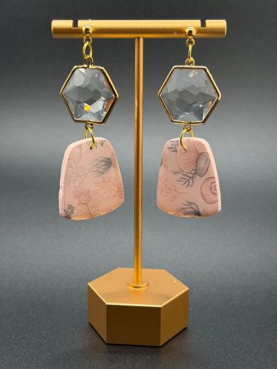 Stylish pink and gray dangle earrings on a gold stand.